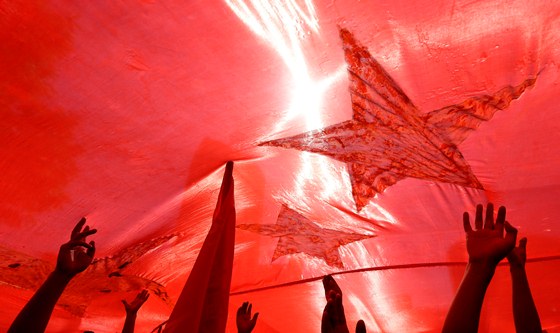 Protesters hold up a giant Chinese national flag during protests outside the Japanese embassy in Beijing, China, Saturday, Sept. 15, 2012. Tensions between the two countries flared anew after the Japanese government bought the disputed islands from their private Japanese owners this week. The uninhabited islands, Senkaku in Japan and Diaoyu in China, claimed by both countries as well as Taiwan, have become a rallying point for nationalists on both sides. (AP Photo/Ng Han Guan)