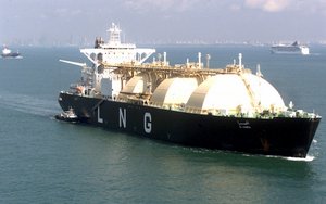 LNG tanker Al Hamra of Iran, sails Singapore strait Friday, May 12, 2000 with a cityscape of Singapore in the background. Ships and tankers, sailing slowly in this narrow strait with a busy traffic, 2,000 ships passing daily, are easy targets for pirates. (AP Photo/Dita Alangkara)